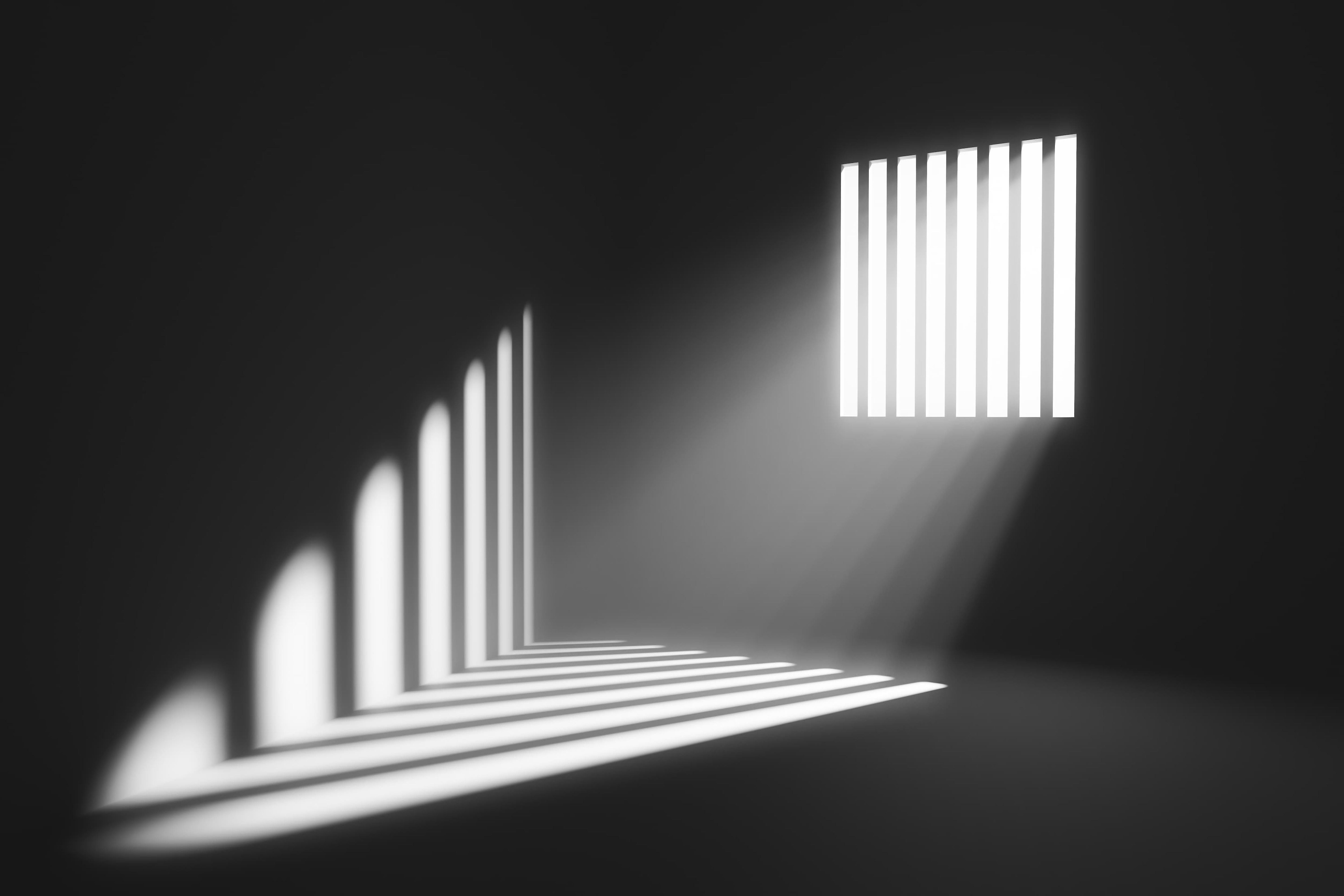 Image of light shining through a barred window